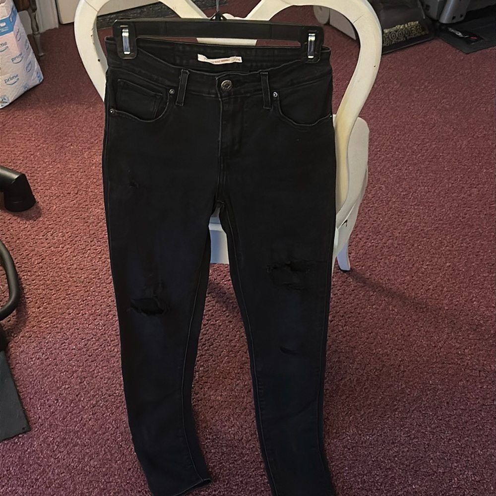 Size 26 high rise Levi’s black jeans, distressed.